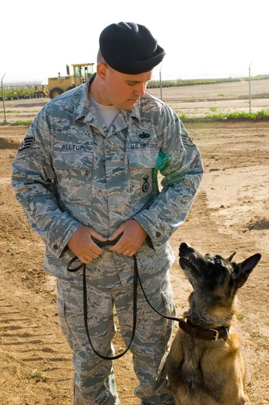 Staff Sgt. Kyle Alltop, 56th Security Forces military working dog handler, works obedience with Roc during his final run of the obstacle course at the Military Working Dog kennels, Luke Air Force Base, Ariz., March 25, 2010. The handlers need to work with the dogs everyday to keep them from losing their edge. (U.S. Air Force Photo by Staff Sgt. Jason Colbert)
