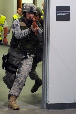 WHITEMAN AIR FORCE BASE, Mo., -- Tech. Sgt. Jonathon Huber and Tech. Sgt. Bryan Gilbert, 509th Security Forces Squadron, charge through a door searching for the person who was attacking the base, during the active shooter exercise here March 24, 2010. The 509th Security Forces Squadron, and many others throughout the Air Force are training to deal with these types of threats from within. Hoping to reduce the number of casualties if such situations occur, a quick and effective response was the goal of the training exercise. (U.S. Air Force photo/Staff Sgt. Jason Huddleston)  (Released)