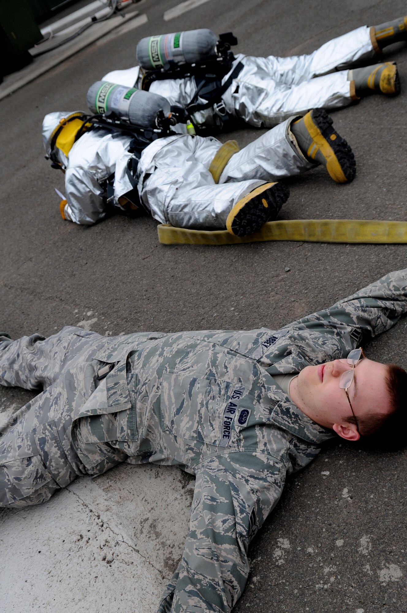 U.S. servicemembers simulate being killed during an exercise on Delta Base, Kapaun Air Station, Germany, March 26, 2010. The 886th Civil Engineer Squadron firefighters conduct at least four exercises per month to ensure readiness in the event of real-world emergency. (U.S. Air Force photo by Airman 1st Class Grovert Fuentes-Contreras)