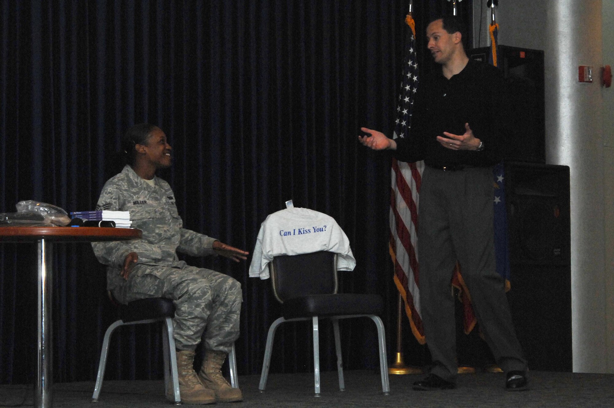 Senior Airman Stephanie Miller, 39th Logistics Readiness Squadron, answers relationship questions with guest speaker, Mr. Mike Domitrz, during the “Can I Kiss You?” briefing Thursday March 25, 2010.  Mike has been speaking with young people and parents in high schools, college campuses, and military instillations for 20 years about dating, healthy relationships and positive communication.