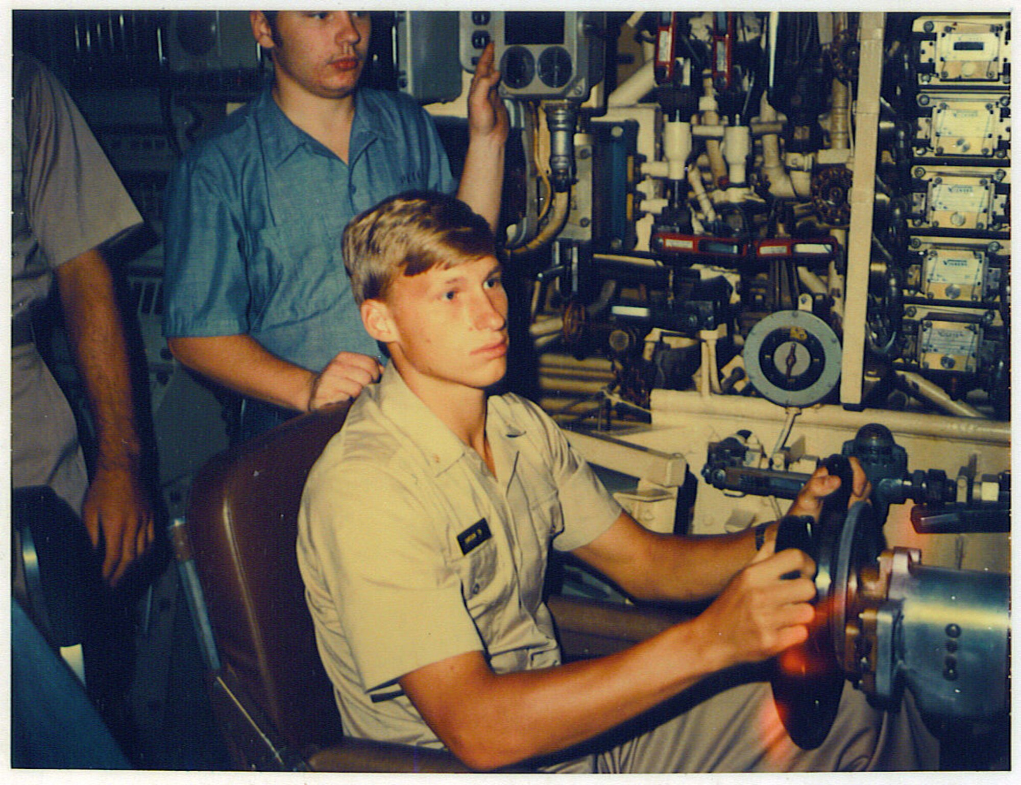 Midshipman Dale Carson, circa 1977, takes the helm of the U.S.S. Hamilton, a ballistic missile submarine, during a U.S. Naval Academy immersion trip to New London, Conn.