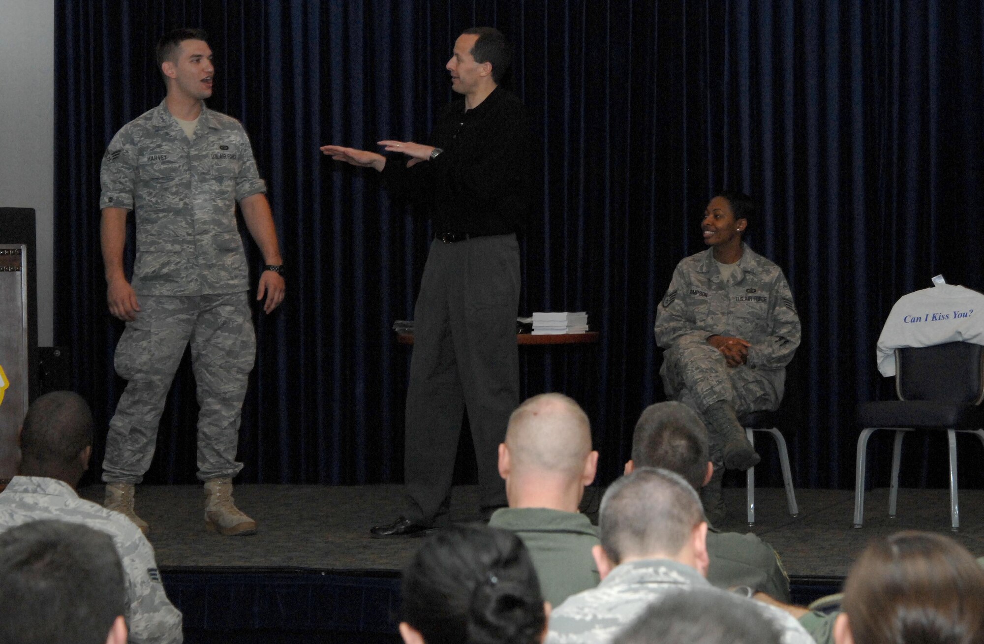 Senior Airman Thomas Harvey, 39th Contracting Squadron, assists guest speaker, Mr. Mike Domitrz, during the “Can I Kiss You?” briefing Thursday March 25, 2010.  Mike has been speaking with young people and parents in high schools, college campuses, and military instillations for 20 years about dating, healthy relationships and positive communication.  (U.S. Air Force photo/Senior Airman Aaron Johnson)