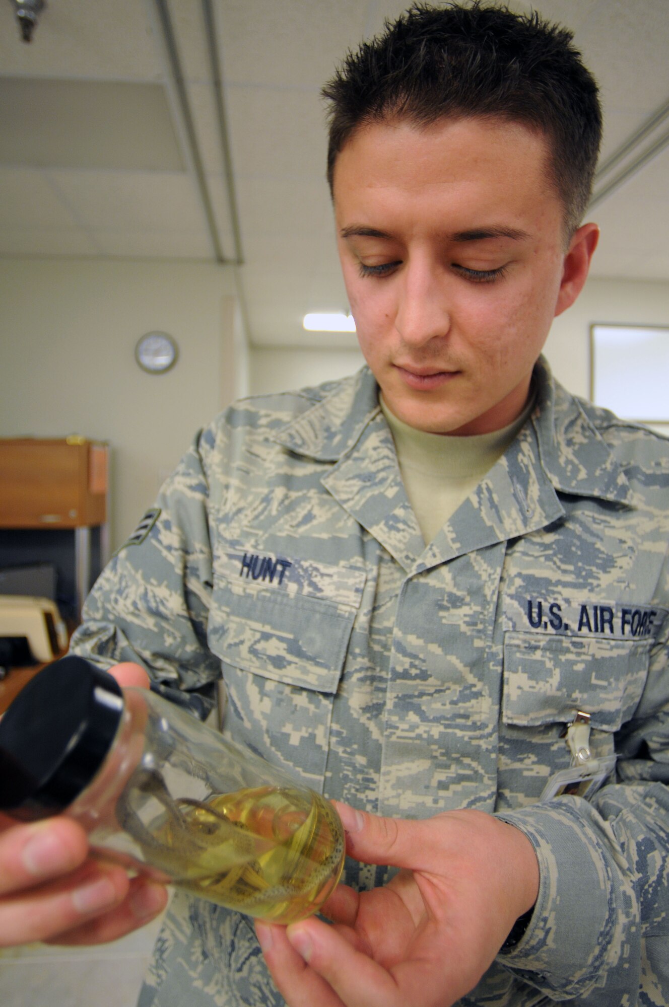 Senior Airman Jonathan Hunt, 39th Medical Group Public Health technician, inspects a preserved snake inside the Public Health shop recently at Incirlik Air Base, Turkey. Public Health’s mission is to prevent disease, disability and premature death. (U.S. Air Force photo/Senior Airman Sara Csurilla)