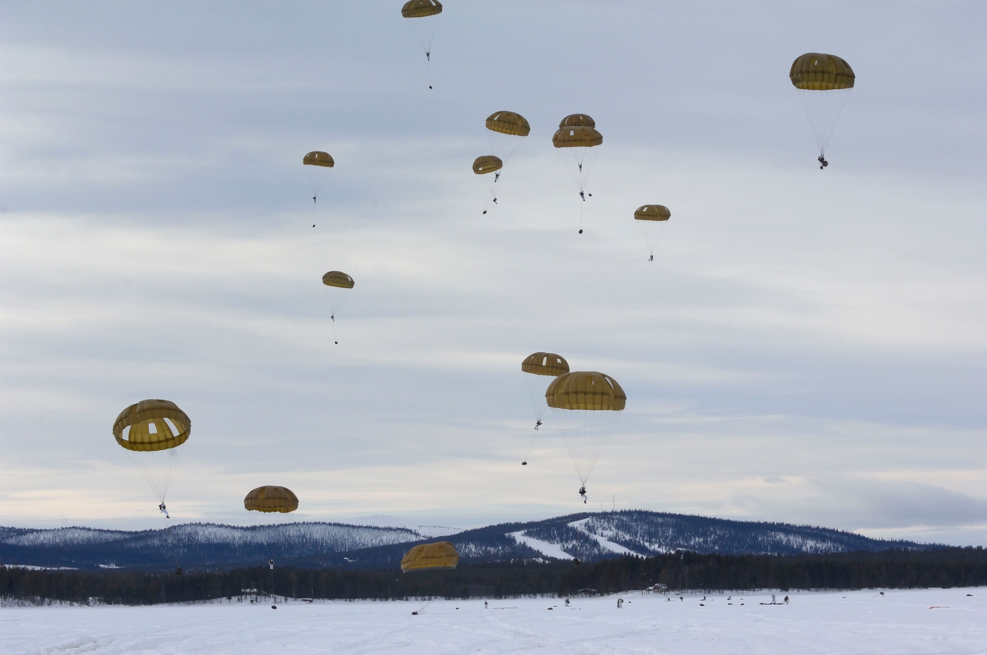 Paratroopers from the Royal Army of the Netherlands complete an airborne operation as part of their winter training exercises in Sweden. The Dutch paratroopers jumped from a U.S. C-130 assigned to the 37th Airlift Squadron. (Photo courtesy of Lt. peter Lankreijer)
