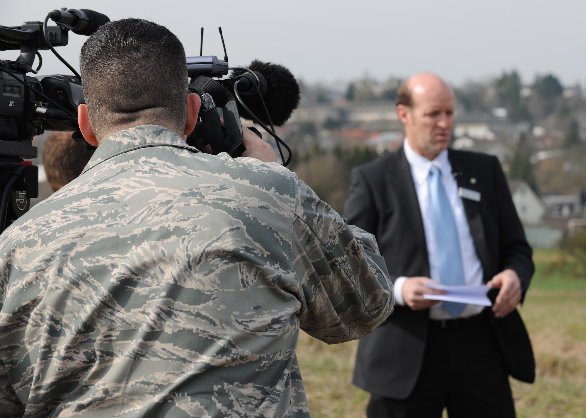 BITBURG, Germany – Staff Sgt. Matthew Bright, 52nd Fighter Wing Public Affairs broadcaster, documents an interview with Rudolph Rinnen, public relations specialist for Volksbank Bitburg, during a press event March 24. Wreckage of a P-47D Thunderbolt was discovered Feb. 24 after being buried for 65 years. German and American reports detail that on Feb. 14, 1945, an American P-47D was shot down in the area. (U.S. Air Force photo/Senior Airman Nathanael Callon)