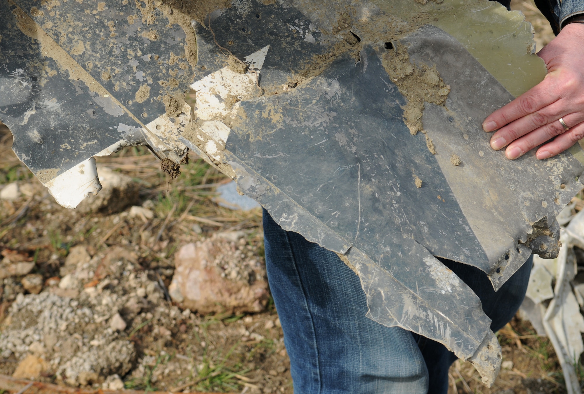 BITBURG, Germany – Horst Weber, member of the Bitburg Area Historical Club, holds a piece of fuselage appearing to be a star from the national insiginia, designating it as a U.S. plane, March 24. Wreckage of the P-47D Thunderbolt was discovered Feb. 24 after being buried for 65 years. (U.S. Air Force photo/Senior Airman Nathanael Callon)