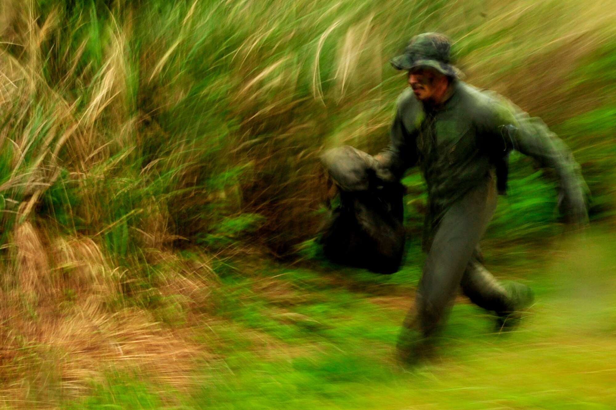 1st Lt. Joseph Bisson, a pilot from the 909th Air Refueling Squadron, runs for cover during an evasion scenario after a simulated KC-135 crash at Kadena Air Base, Japan, March 25. Members of the 909th ARS spent the afternoon training proper survival and evasion procedures. The training was part of Beverly High 10-02, a Local Operational Readiness Exercise designed to evaluate the readiness of Kadena Airmen. (U.S. Air Force photo/Senior Airman Amanda N. Grabiec)