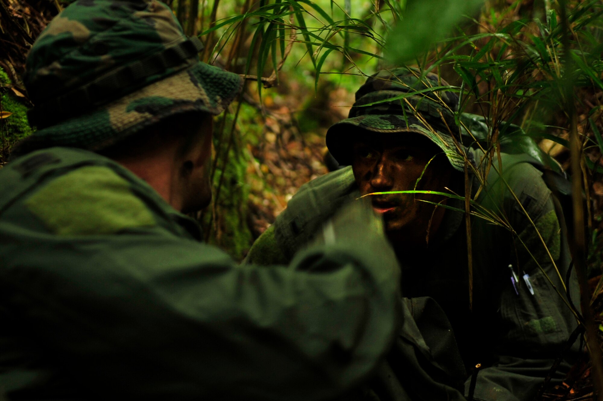 Capt. Aaron Wallace (left) and 1st Lt. Joseph Bisson (right), pilots from the 909th Air Refueling Squadron, discuss their evasion plan after a simulated KC-135 crash at Kadena Air Base, Japan, March 25. Members of the 909th ARS spent the afternoon training proper survival and evasion procedures. The training was part of Beverly High 10-02, a Local Operational Readiness Exercise designed to evaluate the readiness of Kadena Airmen. (U.S. Air Force photo/Senior Airman Amanda N. Grabiec)