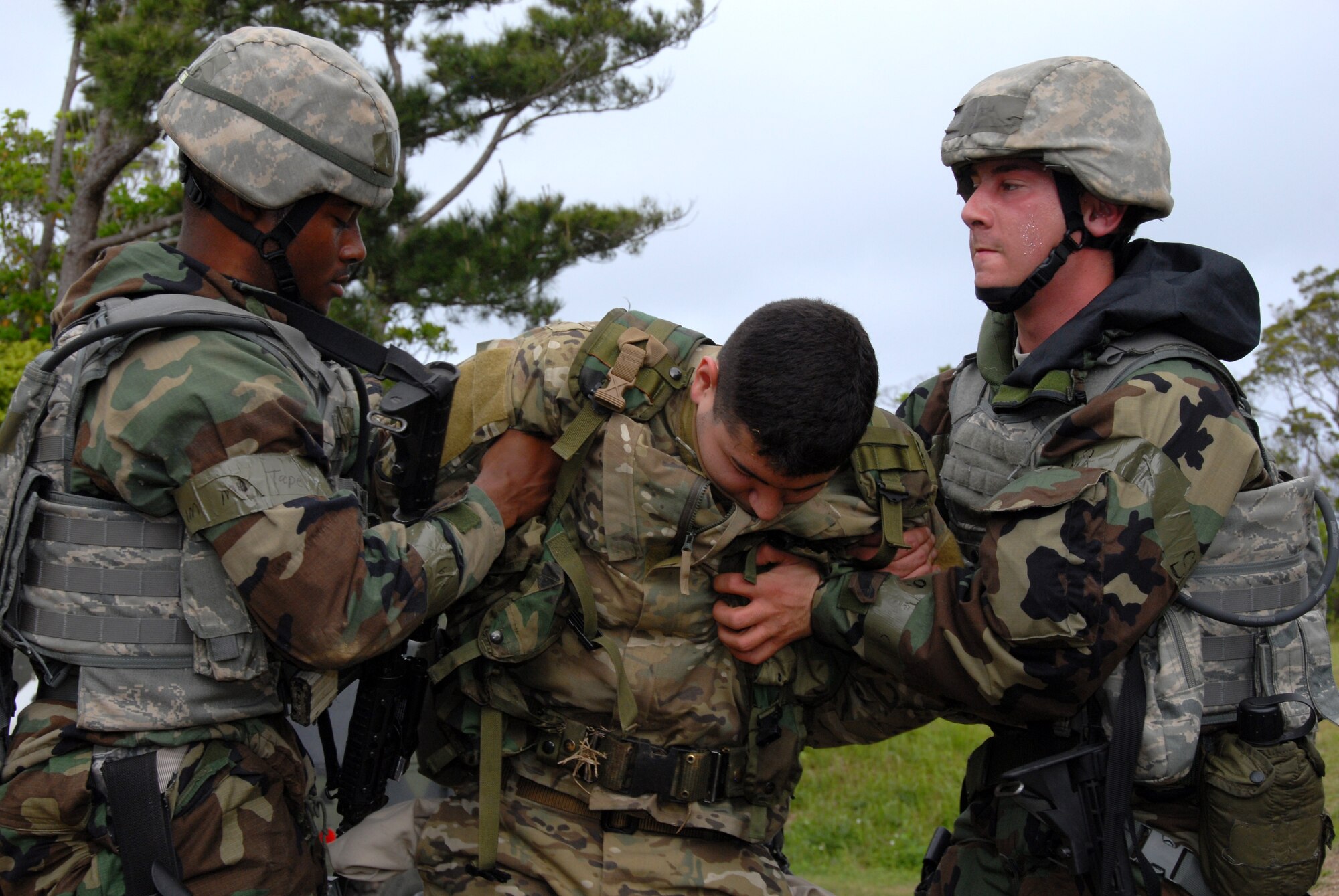 Airman 1st Class Andre Stevenson(left), and Airman 1st Class Andrew Rothstein (right), both 18th Security Forces Squadron members, provide safety and recovery to Senior Airman Spenser Estrada at Area 1 against opposition forces during Beverly High 10-02 at Kadena Air Base, Japan, March 25. The 18th Wing is participating in a Local Operational Readiness Exercise March 22026 to test the readiness of Kadena Airmen. (U.S. Air Force photo/Junko Kinjo)                   
