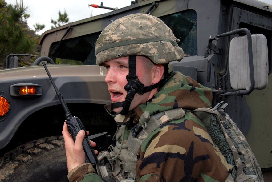 Senior Airman Craig Virginia, 18th Wing Security Forces Squadron pass and registration clerk, and his team come under simulated fire against opposition forces during Beverly High 10-02 at Kadena Air Base, Japan, March 25, 2010. The 18th Wing is participating in a Local Operational Readiness Exercise March 22-26 to test the readiness of Kadena Airmen. (U.S. Air Force photo/Junko Kinjo)