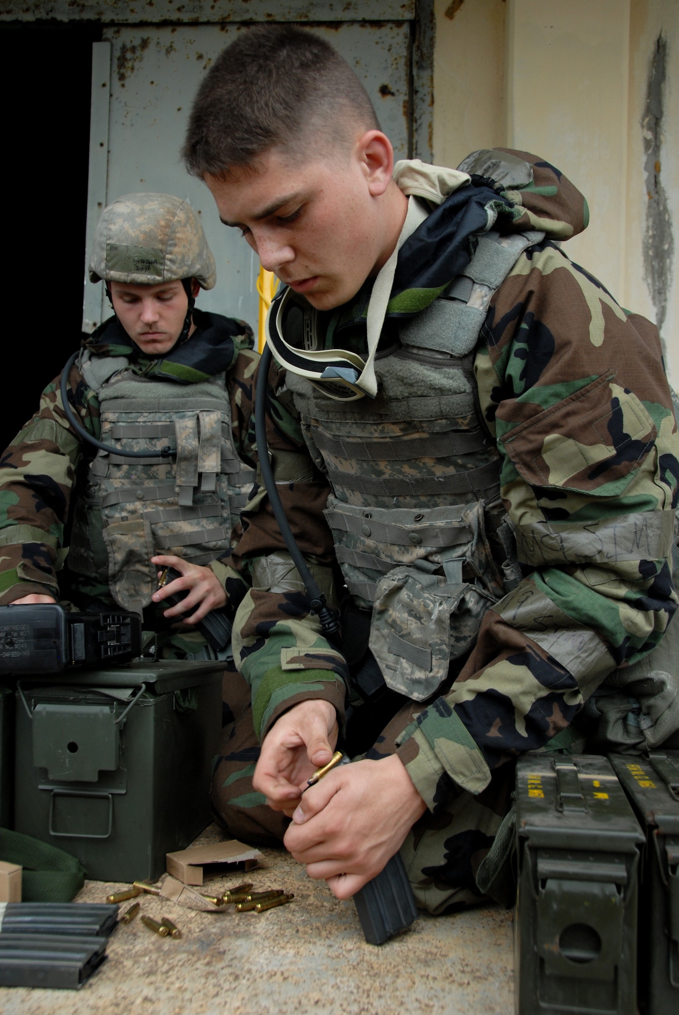 Airman 1st Class Jordan Gunterman, 18th Wing Security Forces Squadron entry controller, loads his magazines before going on a combat patrol at Area 1 against opposition forces during Beverly High 10-02 at Kadena Air Base, Japan, March 25. The 18th Wing is participating in a Local Operational Readiness Exercise March 22026 to test the readiness of Kadena Airmen. (U.S. Air Force photo/Junko Kinjo)         