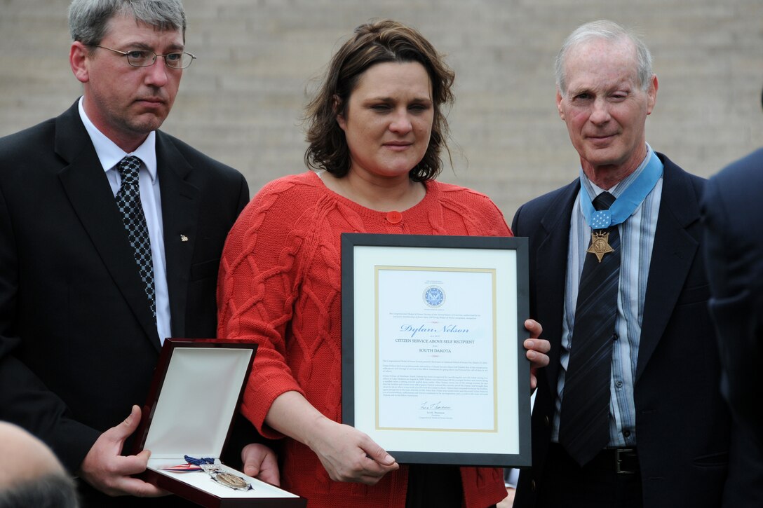 Chad Long and Kristy Nelson, are presented with their son Dylan Nelson's medal for Citizen Service Above Self during a ceremony hosted by the Congressional Medal of Honor Foundation at Arlington National Cemetery, March 25, 2010. Nelson was presented for sacrificing his own life while saving the lives of two others in Lake Madison. 