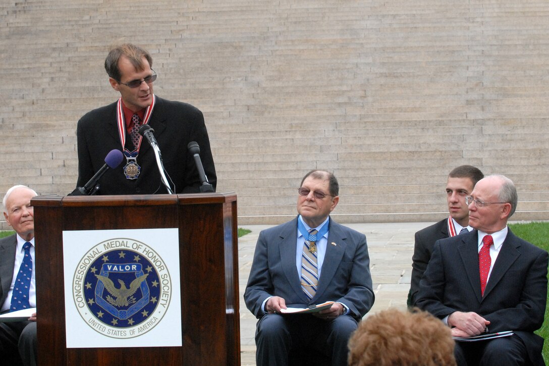 Dr. Jordy Cox of Phoenix, Ariz., who selflessly volunteered and offered his medical skills to perform surgeries in the Congo, Haiti, and the Ivory Coast, speaks after receiving the Citizen Service Above Self Medal from the Congressional Medal of Honor Foundation. 