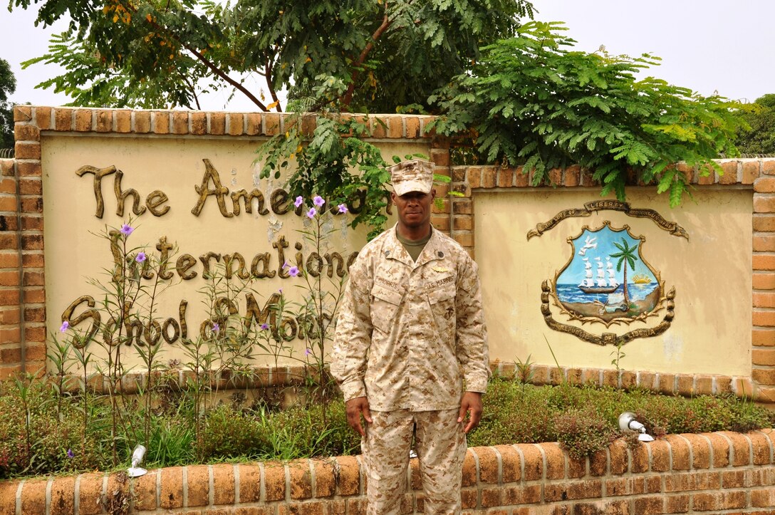 U.S. Marine Corps Staff Sergeant Gary Morris stands in front of the American International School of Monrovia, Liberia where he has been voluntarily teaching a physical education class since February 2010. A reservist, Morris' time in Liberia, which originally began as a voluntary six-month assignment, will end in August 2010, 20 months later. Morris spent eight months serving as a military mentor to the Armed Forces of Liberia and the remaining time has been spent in the Office of Security Cooperation, working as the Liberia Defense Sector Reform liaison and assisting all U.S. military personnel in Liberia with logistical support. Morris recently received notification that he is to be promoted to Gunnery Sergeant.
