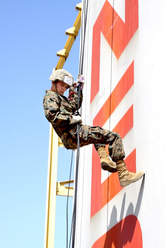 Recruit Brian Shumacher, Platoon 2147, Company G, looks behind him as he wall rappels down the final feet Marine Corps Recruit Depot San Diego's 60-foot rappel tower, March 26. The recruits learned both wall rappel and fast roping. Although this may be the last time the recruits ever rappel, the exercise can be useful in combat military occupational specialties. Sgt. Carrie C. Booze/Chevron