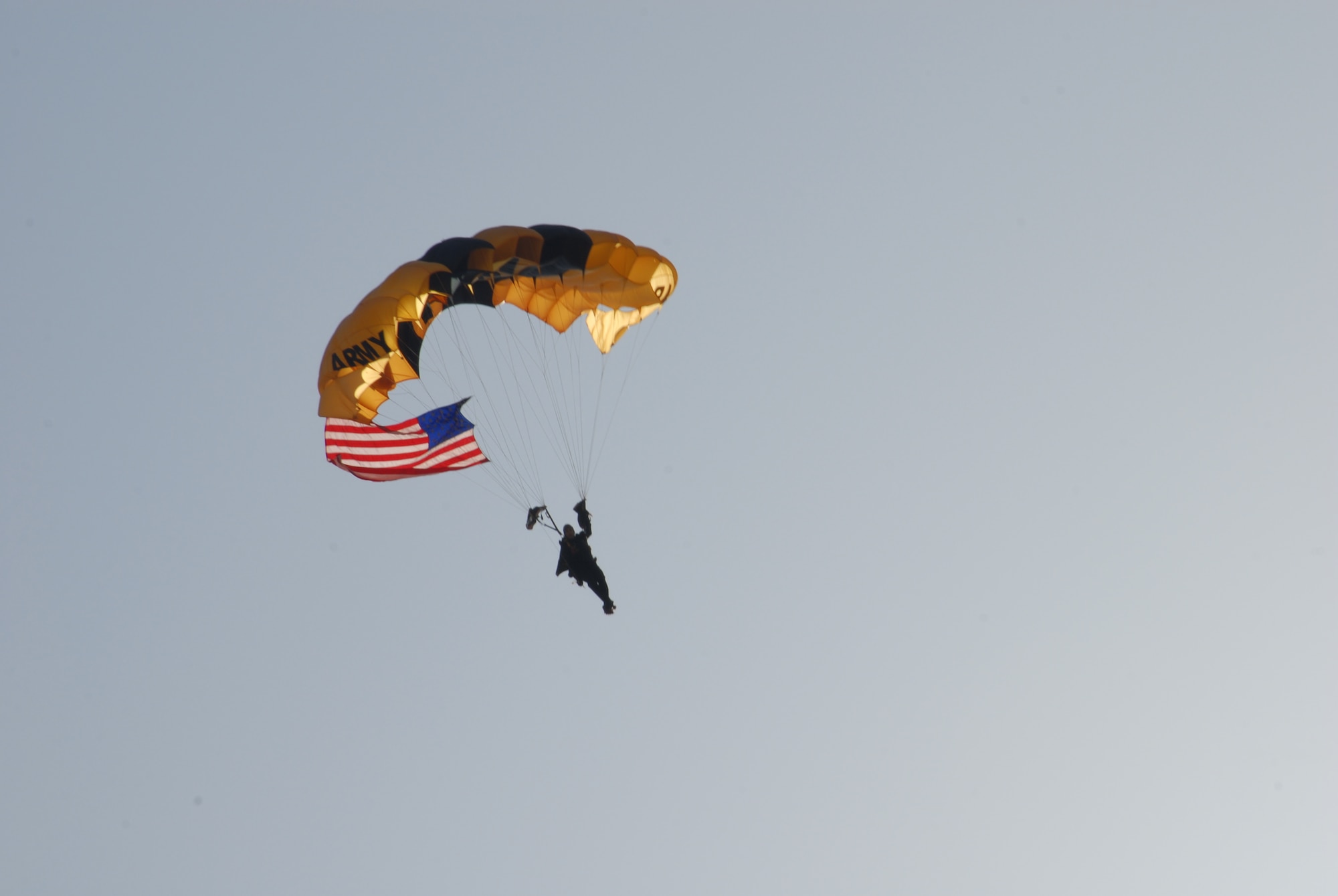 One of the U.S. Army Golden Knights parachute team jumpers carries the American flag to the flighline of the Thunder Over Alabama air show at Maxwell Air Force Base on March 27, 2010. The Maxwell Open House and Air Show is celebrating 100 years of flight over Alabama. (U.S. Air Force photo/Bennett Rock)