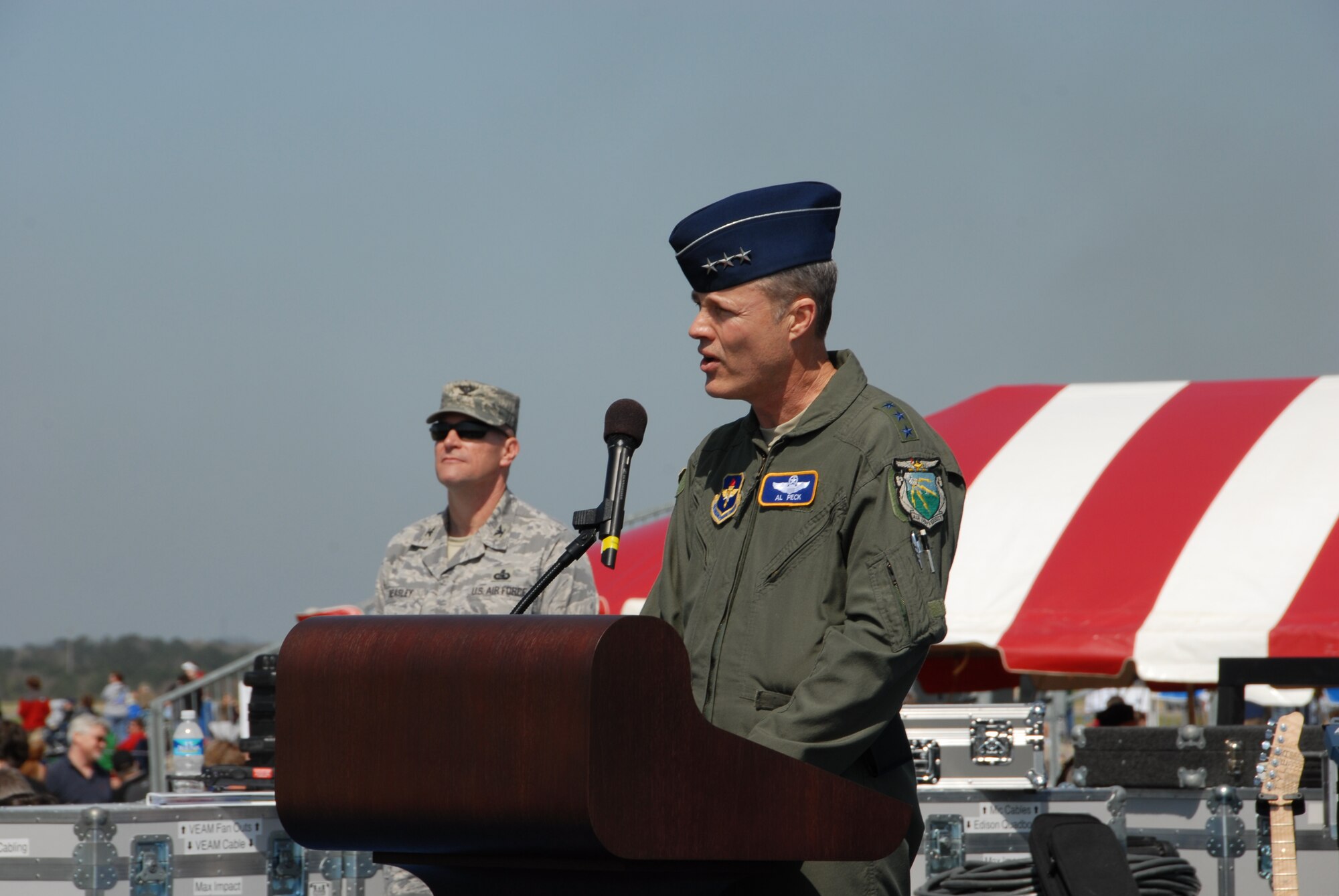 Lt. Gen. Allen Peck, Air University commander, speaks at the Thunder Over Alabama air show welcome ceremony as Col. Kris Beasley, 42nd Air Base Wing commander, looks on March 27, 2010. The Maxwell Open House and Air Show is celebrating 100 years of flight over Alabama. (U.S. Air Force photo/Bennett Rock)