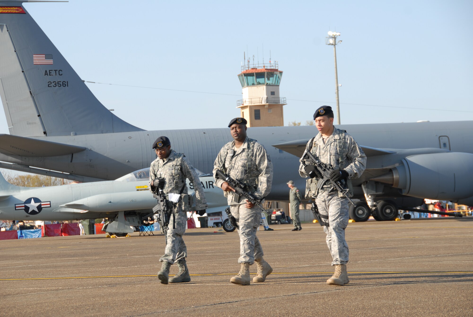 Three Airmen from the 42nd Security Forces Squadron at Maxwell Air Force Base, Ala. patrol the flightline before the gates open at the Thunder Over Alabama air show here March 27, 2010. The Maxwell Open House and Air Show is celebrating 100 years of flight over Alabama. (U.S. Air Force photo/Jamie Pitcher)