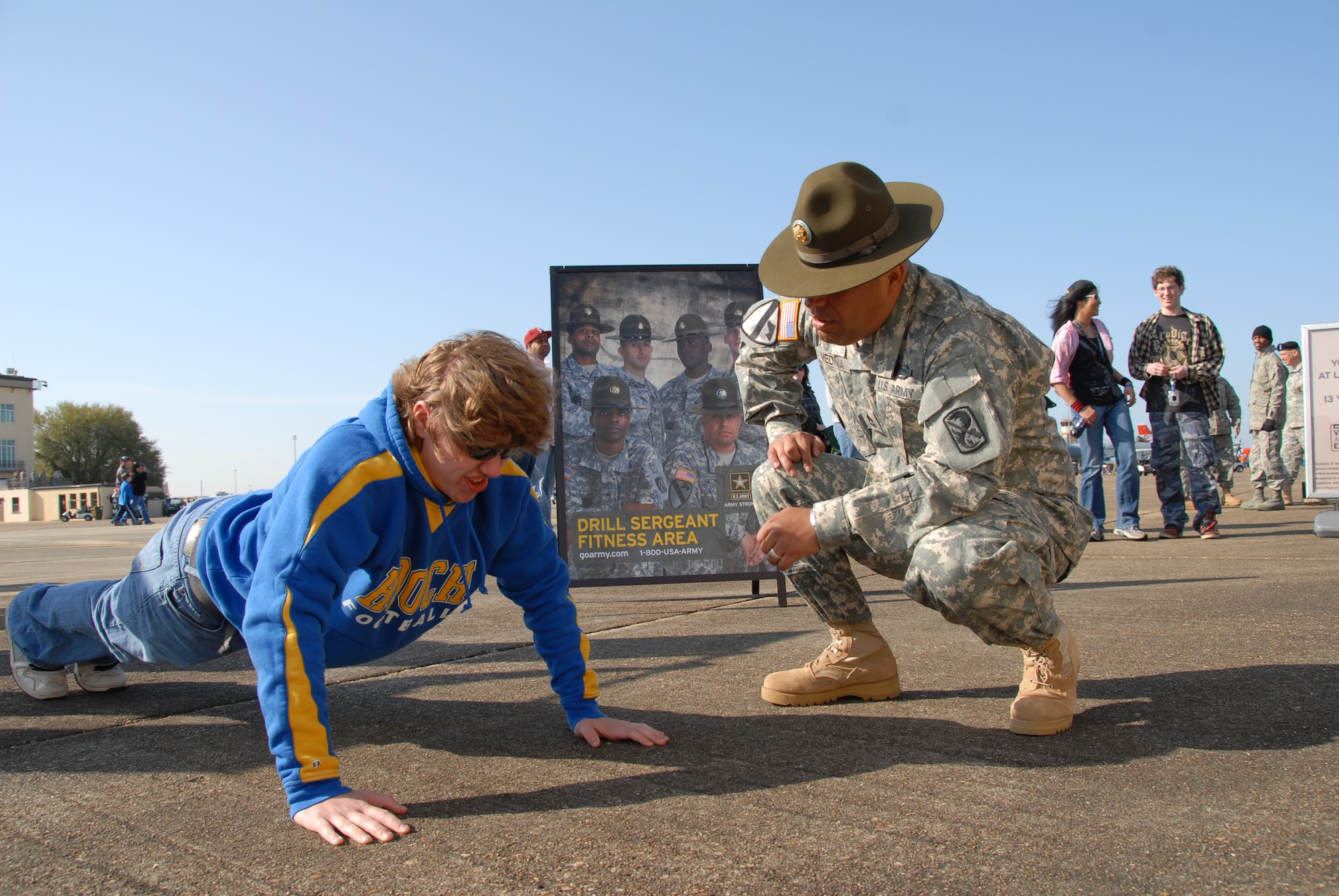 Sgt. 1st Class Miguel Medina Jr., an Army recruiter, counts as Ryan Clancy of Alpharetta, Ga. does push ups trying to win a T-shirt at the Thunder Over Alabama air show at Maxwell Air Force Base on March 27, 2010. The Maxwell Open House and Air Show is celebrating 100 years of flight over Alabama. (U.S. Air Force photo/Jamie Pitcher)