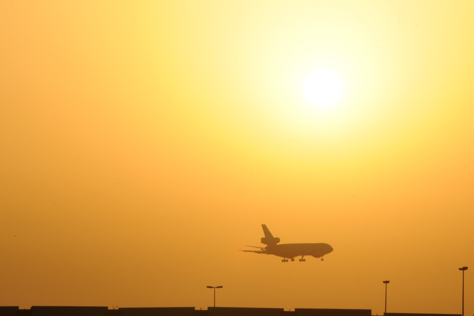 A KC-10 Extender lands as the suns sets over the 380th Air Expeditionary Wing at an undisclosed location in Southwest Asia on March 25, 2010. The 380th Air Expeditionary Wing, supports operations Iraqi Freedom and Enduring Freedom and the Combined Joint Task Force-Horn of Africa. The 380th AEW is comprised of four groups and 12 squadrons and the wing's deployed mission includes air refueling, surveillance and reconnaissance in support of overseas contingency operations in Southwest Asia. (U.S. Air Force photo/Senior Airman Jenifer H. Calhoun/Released)
