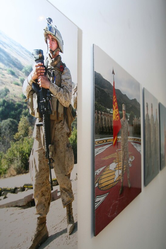 The "Honor: Marine Portraits" exhibit with photographs of San Diego Marines stands on display in the Oceanside Museum of Art March 27. The photographer, Stathis Orphanos, captured hundreds of photographs of Maines in various uniforms and training events.