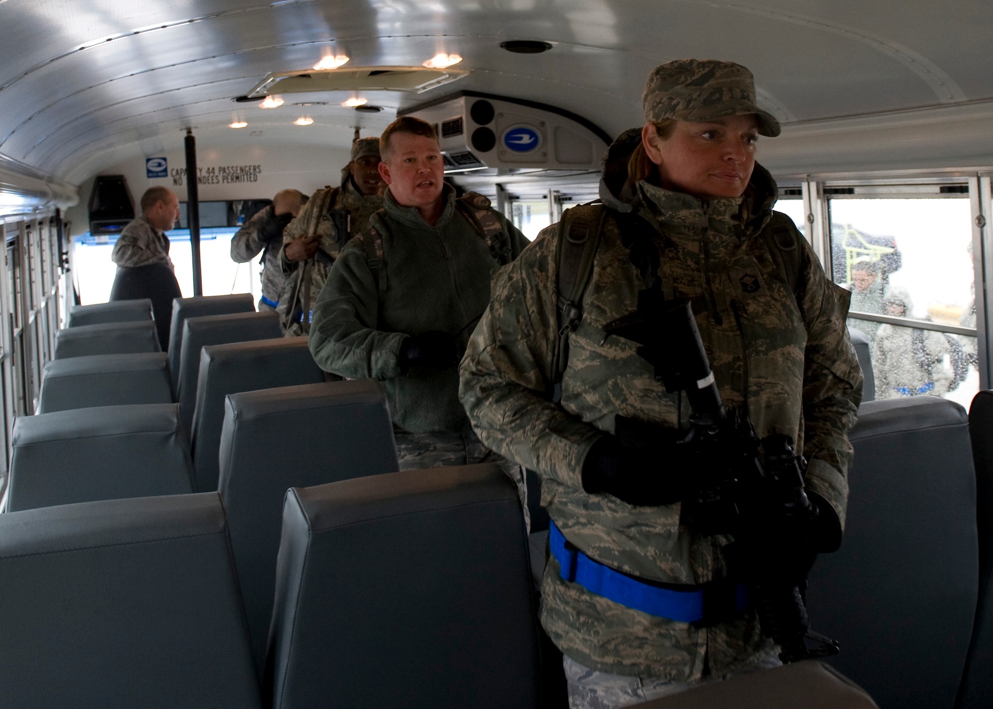 SCOTT AIR FORCE BASE, Ill. -- Airmen from the 375th Air Mobility Wing board a bus to be transported to Hangar 1 after returning from an Operational Readiness Inspection that was held at the Volk Field Combat and Readiness Training Center, Wis. The Airmen will return issued equipment, retrieve their bags and then will be released to their respective units. (U.S. Air Force photo/Staff Sgt. Paul Villanueva II)