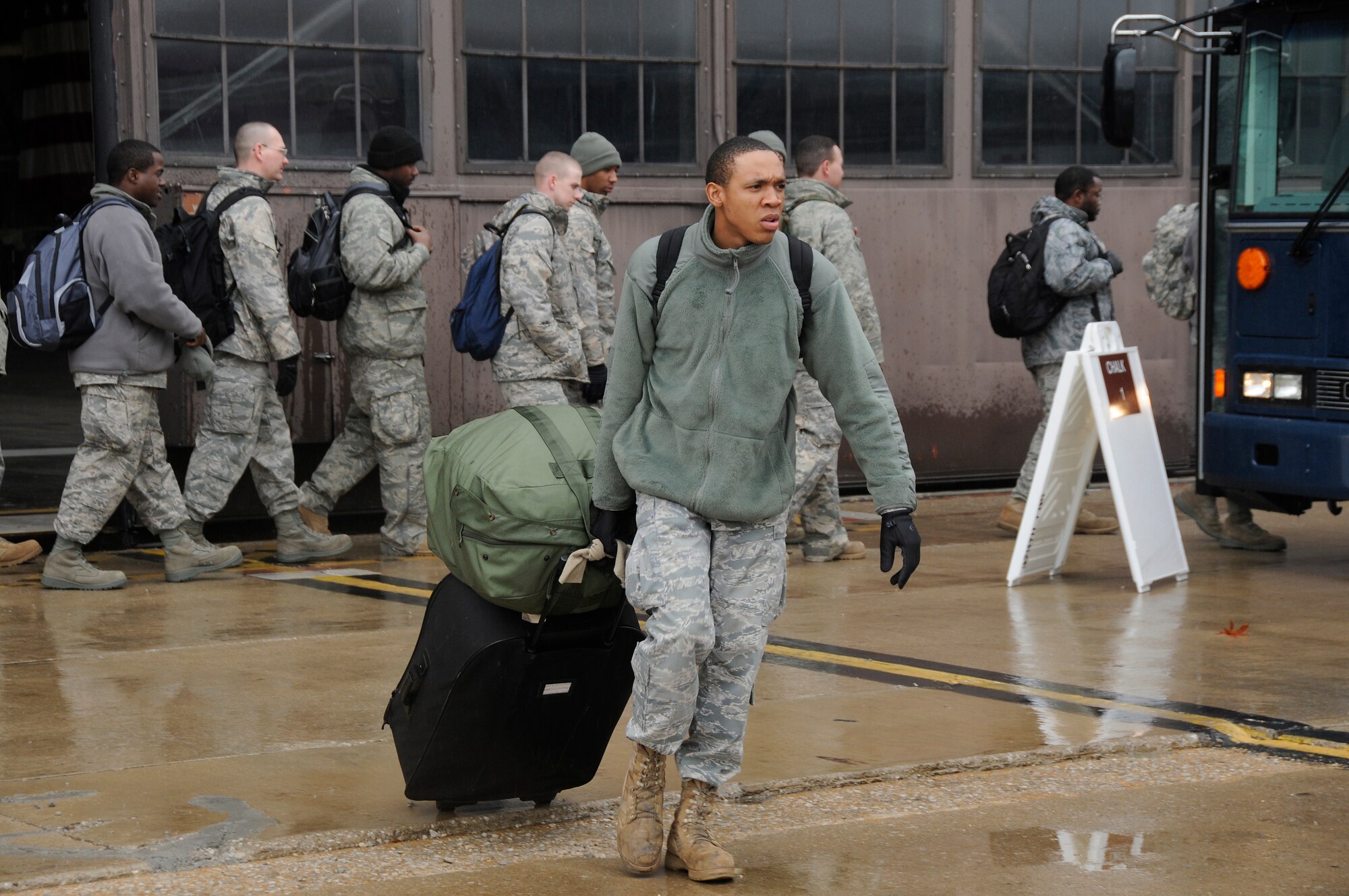 SCOTT AIR FORCE BASE, Ill. -- An Airman from the 375th Air Mobility Wing drags his bags to a bus that will take him back to his unit after returning to Scott AFB March 28, 2010 from the Volk Field Combat Readiness and Training Center, Wis. as part of an Operational Readiness Inspection. The 375th AMW was graded by the Air Mobility Command Inspector General to ensure they are ready to deploy combat ready Airmen at a moments notice. Results will be released April 2. (U.S. Air Force photo by Staff Sgt. Brian J. Ellis)