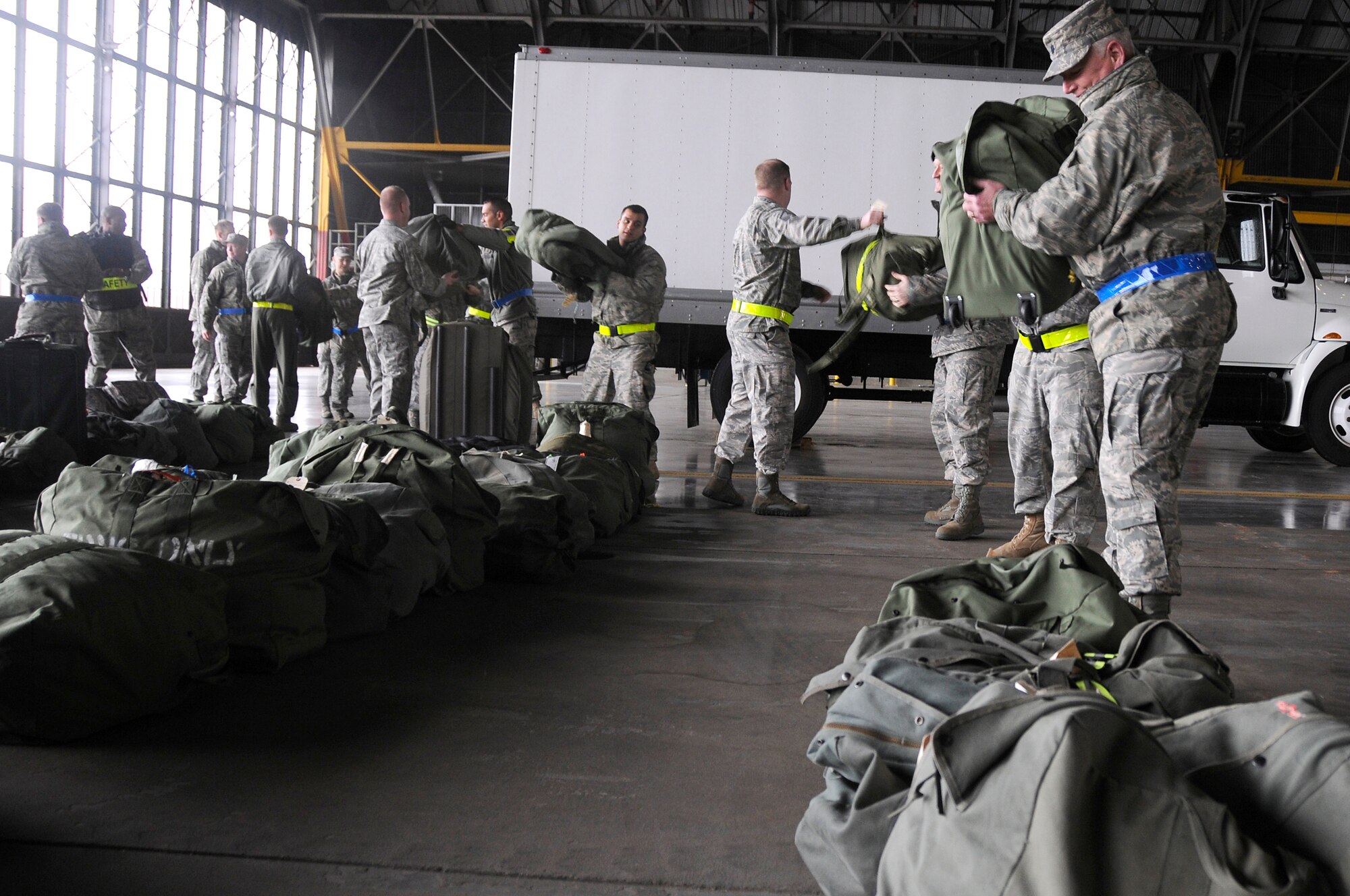 SCOTT AIR FORCE BASE, Ill. -- Airmen from the 375th Air Mobility Wing unload bags belonging to deployees after their return to Scott AFB from the Volk Field Combat Readiness and Training Center, Wis., as part of an Operational Readiness Inspection March 28, 2010. The ORI is done to test the wing's ability to deploy its personnel and equipment at a moments notice in the event of a real world incident. (U.S. Air Force photo by Staff Sgt. Brian J. Ellis)