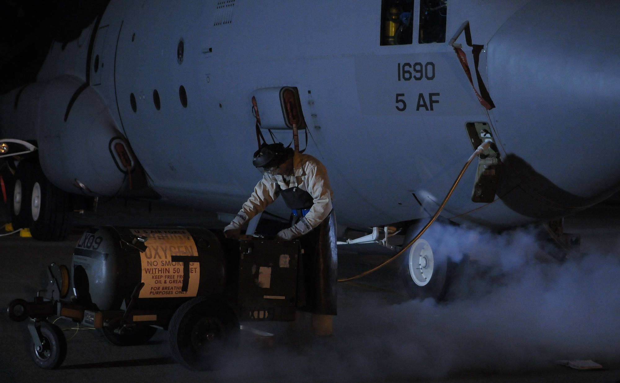 YOKOTA AIR BASE, Japan -- Airman 1st Class Dustin Lingel, 374th Maintenance Squadron crew chief, uses a liquid oxygen cart to prepare an aircraft for launch here March 29. (U.S. Air Force photo/Airman 1st Class Sean Martin)