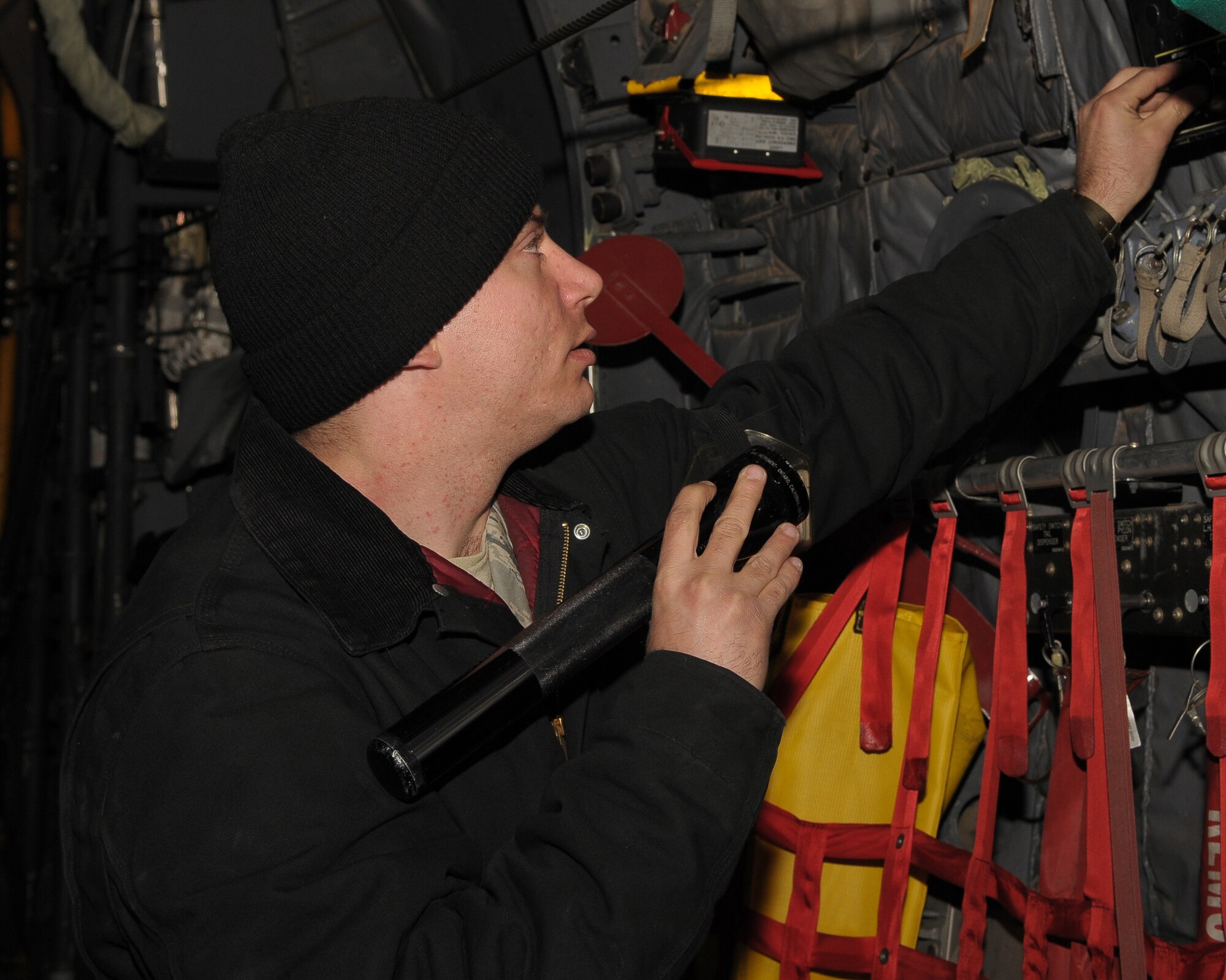 YOKOTA AIR BASE, Japan -- Staff Sgt. Chris Bailey, 374th Maintenance Squadron crew chief, performs a pre-flight inspection on a C-130 Hercules March 29 during an exercise here. The exercise was held to test Yokota's operational readiness. (U.S. Air Force photo/Airman 1st Class Sean Martin)