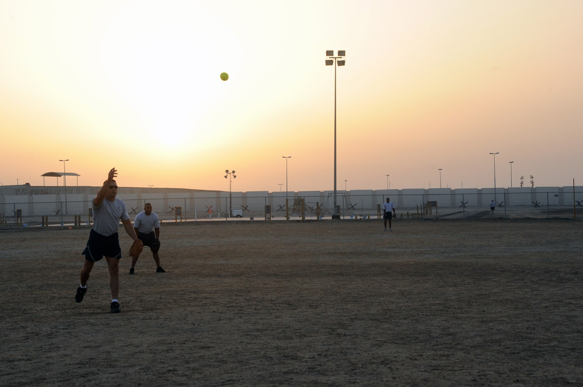Airmen from the 380th Air Expeditionary Wing play a game of softball on a sand field at a non-disclosed base in Southwest Asia on March 25, 2010.  (U.S. Air Force Photo/Senior Airman Jenifer Calhoun/Released)