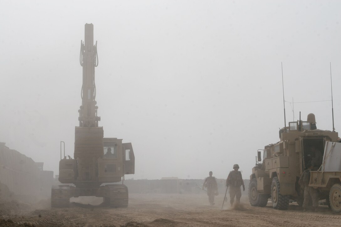 Marines go about digging trenches and enforcing walls at Forward Operating Base Marjah, March 30. The construction of the base began in early March and serves as a key center of operations within the city of Marjah, Afghanistan.