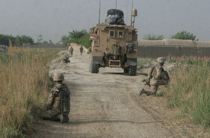 Marines from Weapons Company, 2nd Battalion, 2nd Marine Regiment, take a short security halt during a patrol down Route Giants in Laki, Garmsir District, Helmand province, Afghanistan, March 30. Marines patrolled southward to establish a new patrol base to more easily conduct patrols and operations in the more southern portion of their area of operations. \