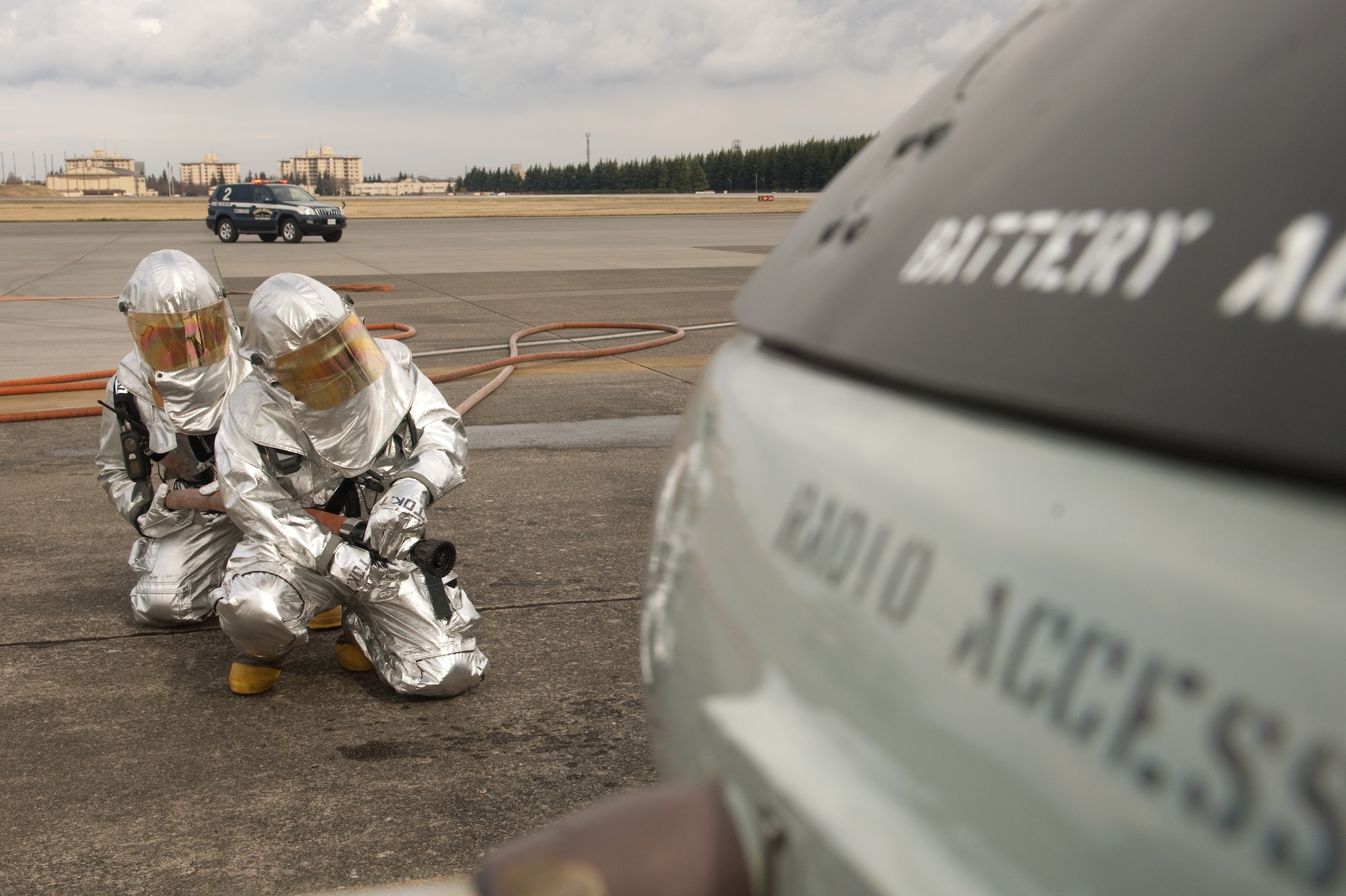 YOKOTA AIR BASE, Japan -- Yokota firefighters prepare to fight a simulated fire here March 29, during a UH-1 Huey egress and fire exercise. The exercise tested Yokota Airmen's operational readiness preparedness.  (U.S. Air Force photo/Osakabe Yasuo)