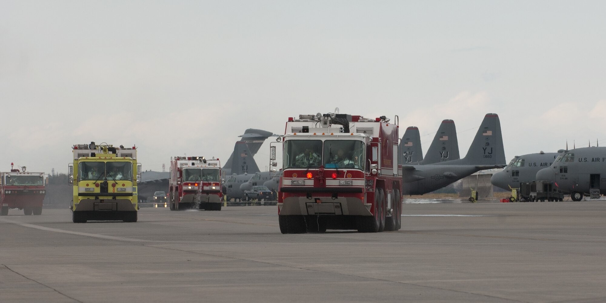 YOKOTA AIR BASE, Japan -- Fire trucks from the 374th Civil Engineer Squadron dispatch to a simulated UH-1 Huey egress and fire here March 29. The exercise tested Yokota Airmen's operational readiness preparedness.  (U.S. Air Force photo/Osakabe Yasuo)