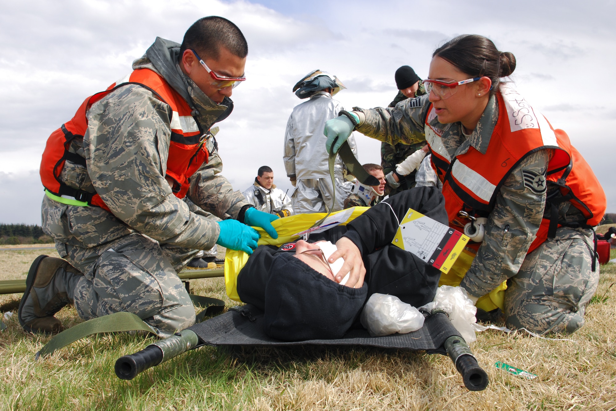 YOKOTA AIR BASE, Japan -- Airman 1st Class Ivan Jarusiri (left) and Staff Sgt. Carleen Wallace (right), both from 374th Medical Group, work to stabilize a simulated vehicle accident patient during an operational readiness exercise here March 29. The exercise challenged first responders to perform initial response, casualty management, and ambulance loading procedures on victims of a simulated vehicle accident. (U.S. Air Force photo/Osakabe Yasuo)