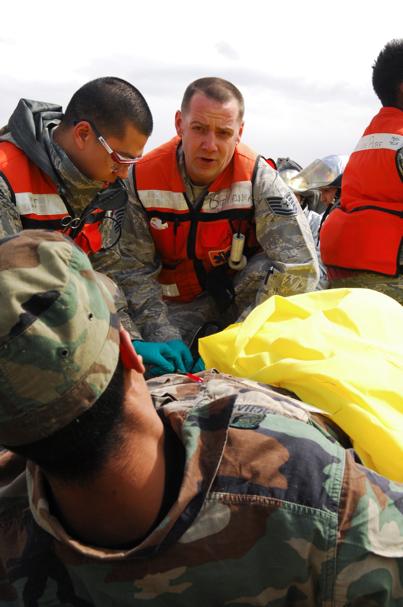 YOKOTA AIR BASE, Japan -- Tech. Sgt. Nathan Mainer (center), 374th Medical Group technician, secures a simulated patient for transfer during an operational readiness exercise here March 29. The exercise challenged first responders to perform initial response, casualty management, and ambulance loading procedures on victims of a simulated vehicle accident. (U.S. Air Force photo/Osakabe Yasuo)