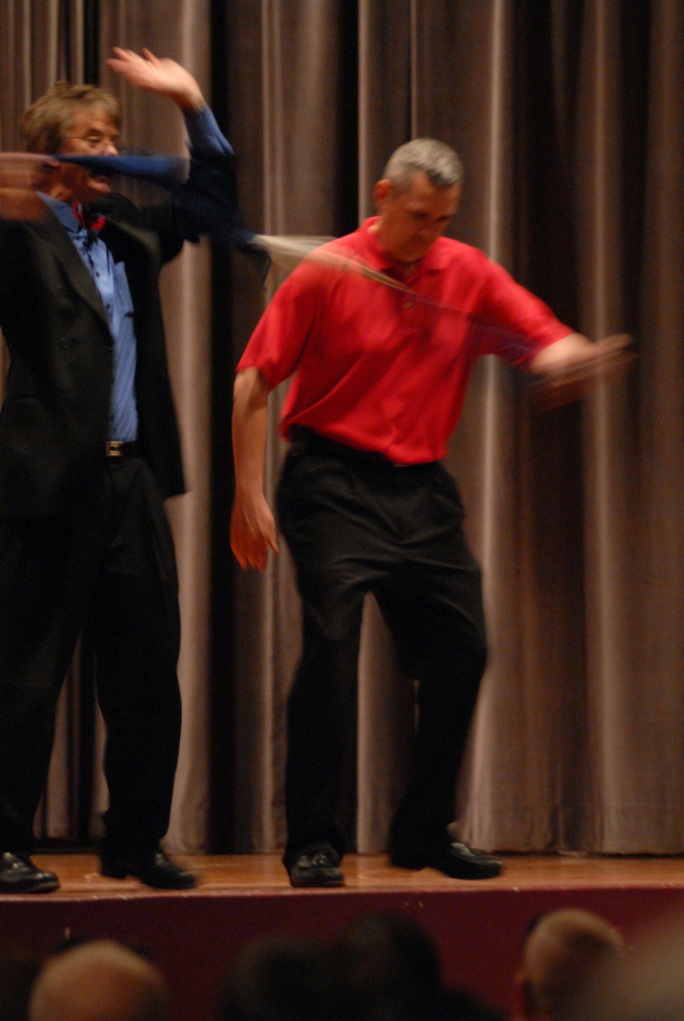 VANDENBERG AIR FORCE BASE, Calif. -- As part of his final trick, magician Matt Fore pulls pieces of colored silk from the belt of Chaplain (Capt.) Mark Thomas, of the 30th Space Wing, during a magic show held in the base theater here Sunday, March 28, 2010. Deviating from his usual forum of after-dinner entertainment and church functions, Mr. Fore performed for military members and their families. (U.S. Air Force photo/Airman 1st Class Angelina Drake)