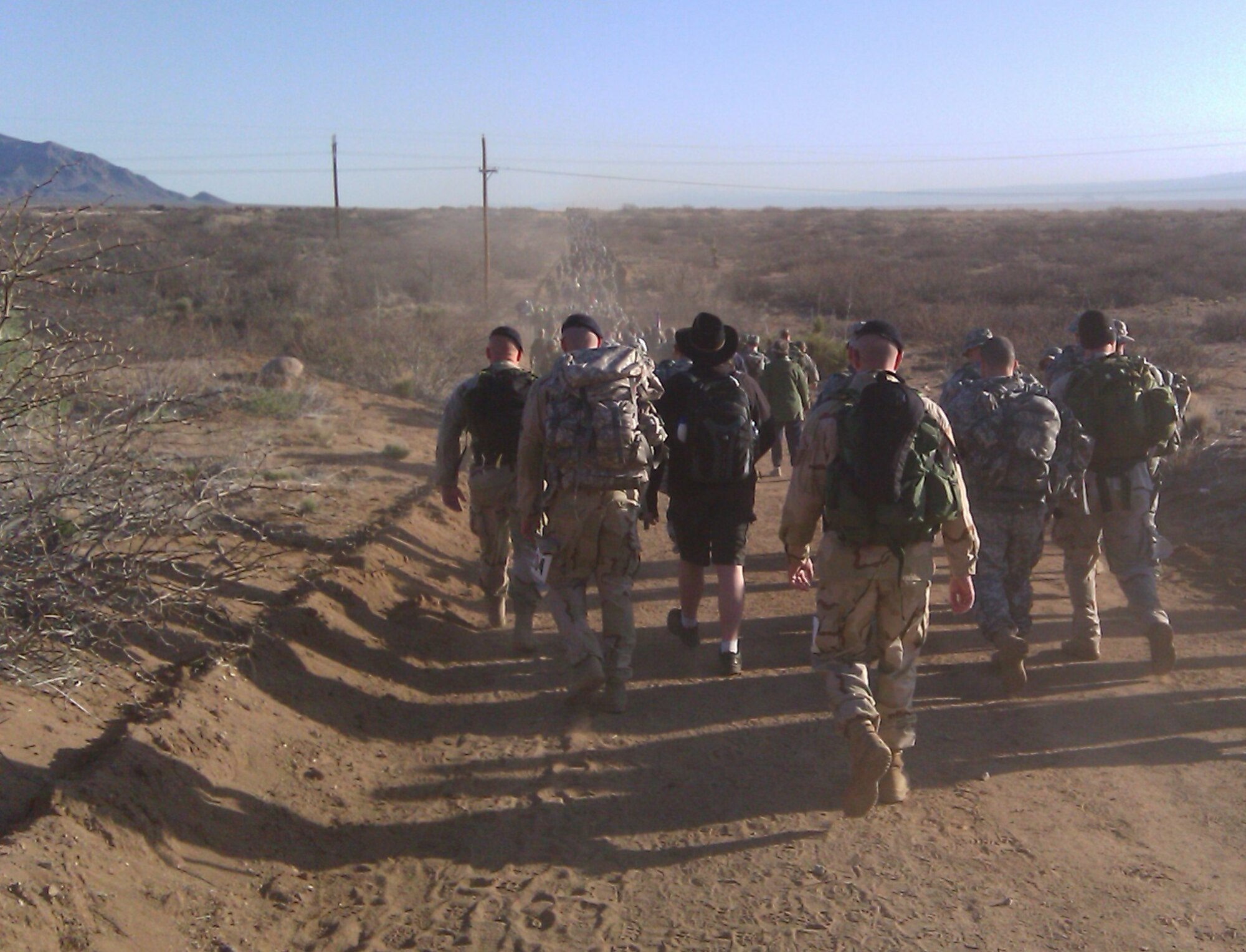 From left: Staff Sgt. Anthony Odell, 1st Lt. Derek Tosie, Jerry Haupt and Maj. Michael Borders, 56th Security Forces Squadron, march with thousands of participants toward the horizon during the Bataan Memorial Death March at White Sands Missile Range, N.M. March 21. Each of the five participants finished the 26.2 mile march with a rucksack on their backs, each pack weighing between 35 and 51 pounds. (U.S. Air Force photo courtesy 56th Security Forces Squadron)