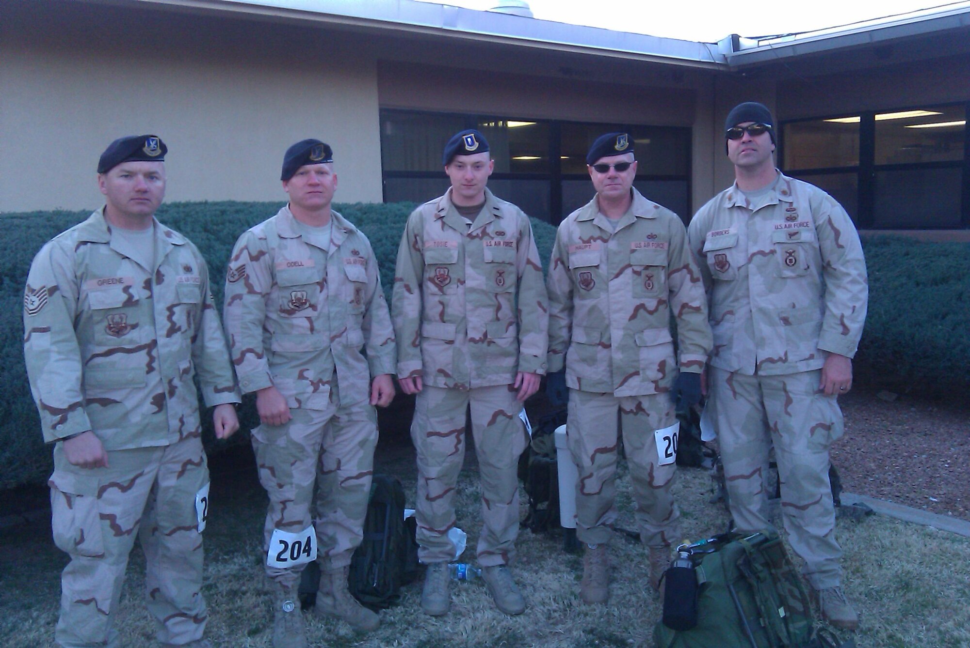 Tech. Sgt. Adam Greene, Staff Sgt. Anthony Odell, 1st Lt. Derek Tosie, Jerry Haupt and Maj. Michael Borders, 56th Security Forces Squadron, pose for a photo prior to beginning the Bataan Memorial Death March at White Sands Missile Range, N.M. March 21. The Desert Combat Uniforms shown are what each wore during their previous deployments. (U.S. Air Force photo courtesy 56th Security Forces Squadron)