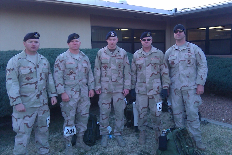 From left to right, Tech. Sgt. Adam Greene, Staff Sgt. Anthony Odell, 1st Lt. Derek Tosie, Jerry Haupt and Maj. Michael Borders, 56th Security Forces Squadron, pose for a photo prior to beginning the Bataan Memorial Death March at White Sands Missile Range, N.M., March 21. The Desert Combat Uniforms shown are what each wore during their previous deployments. (U.S. Air Force Courtesy Photo) 
