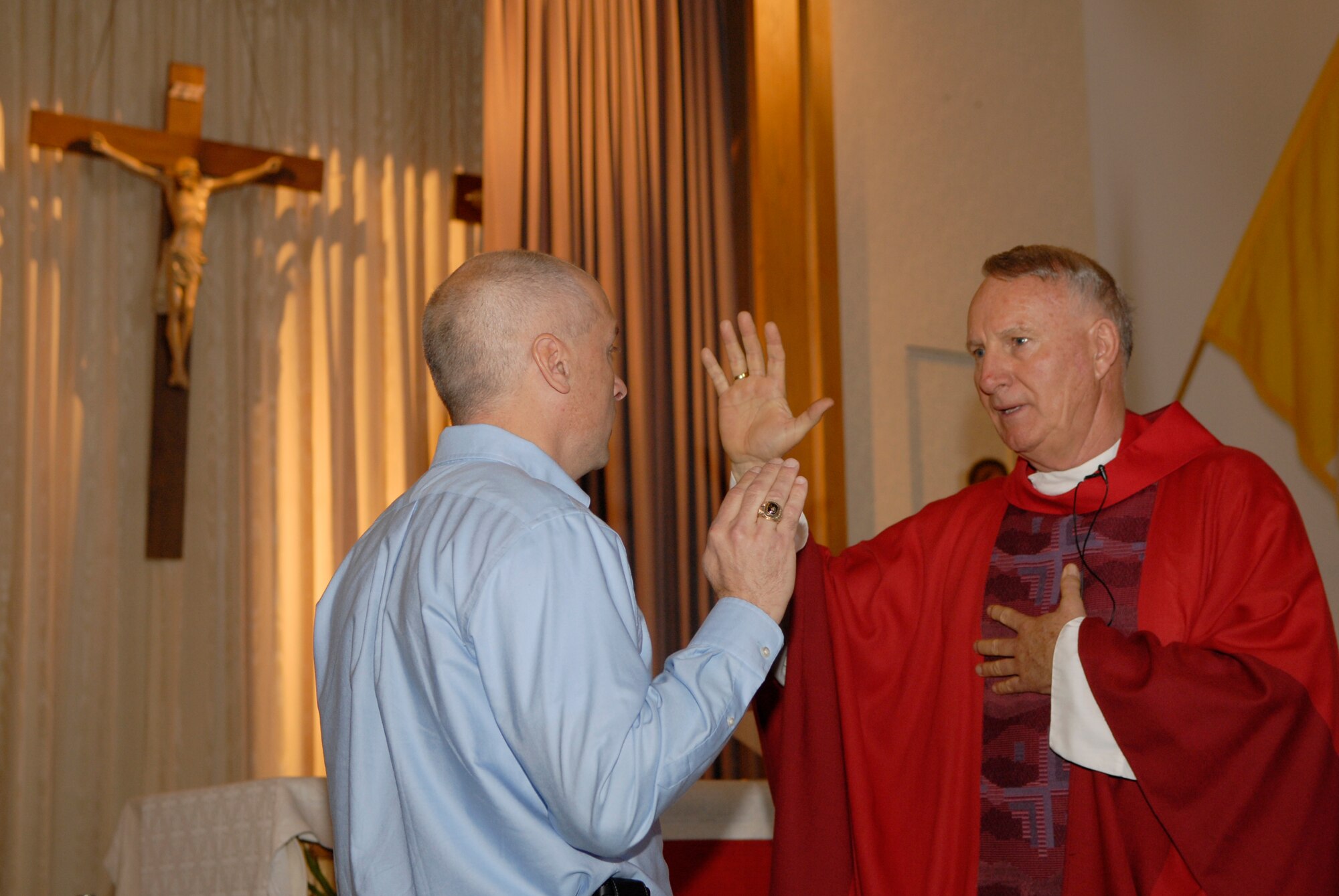 VANDENBERG AIR FORCE BASE, Calif. -- Air Force Reserve Chaplain (Lt. Col.) Thomas Kelly, the 30th Space Wing civilian Catholic priest, is inducted to the full-time civilian position by Col. Richard Boltz, the 614th Air and Space Operations Center commander, in the base chapel Sunday, March 28, 2010.  Chaplain Kelly performs his reserve duties from the 61st Air Base Wing, Los Angeles Air Force Base. (U.S. Air Force photo/Senior Airman Andrew Satran) 

 