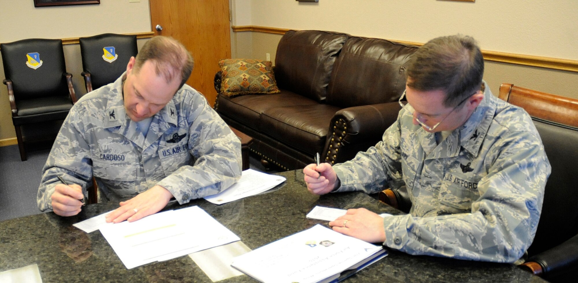 (Left to right) Col. James Cardoso, 27th Special Operations Wing vice commander, and Col. Stephen Clark, 27 Special Operations Wing Commnder, make the first donations to the Air Force Assistance Fund March 25. The Air Force Assistance Fund campaign is in full swing at Cannon through May 7 with a goal this year of $57,000. For information on how this organization supports Air Force families, visit http://afassistancefund.org. (U.S. Air Force Photo by Senior Airman Evelyn Chavez)
