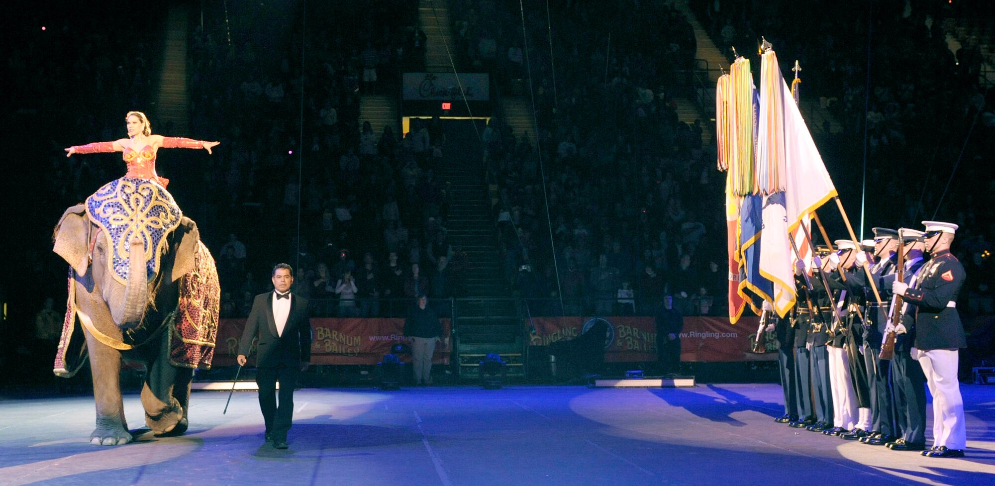 The Military District of Washington's Joint Color Guard present the flags as a two ton Asian elephant helps open the Ringling Bros. and Barnum & Bailey "Zing Zang Zoom" circus performance March 26, 2010, at George Mason University's Patriot Center in Fairfax, Va. This particular performance was in honor of military families worldwide.  (U.S. Air Force photo/Jim Varhegyi)