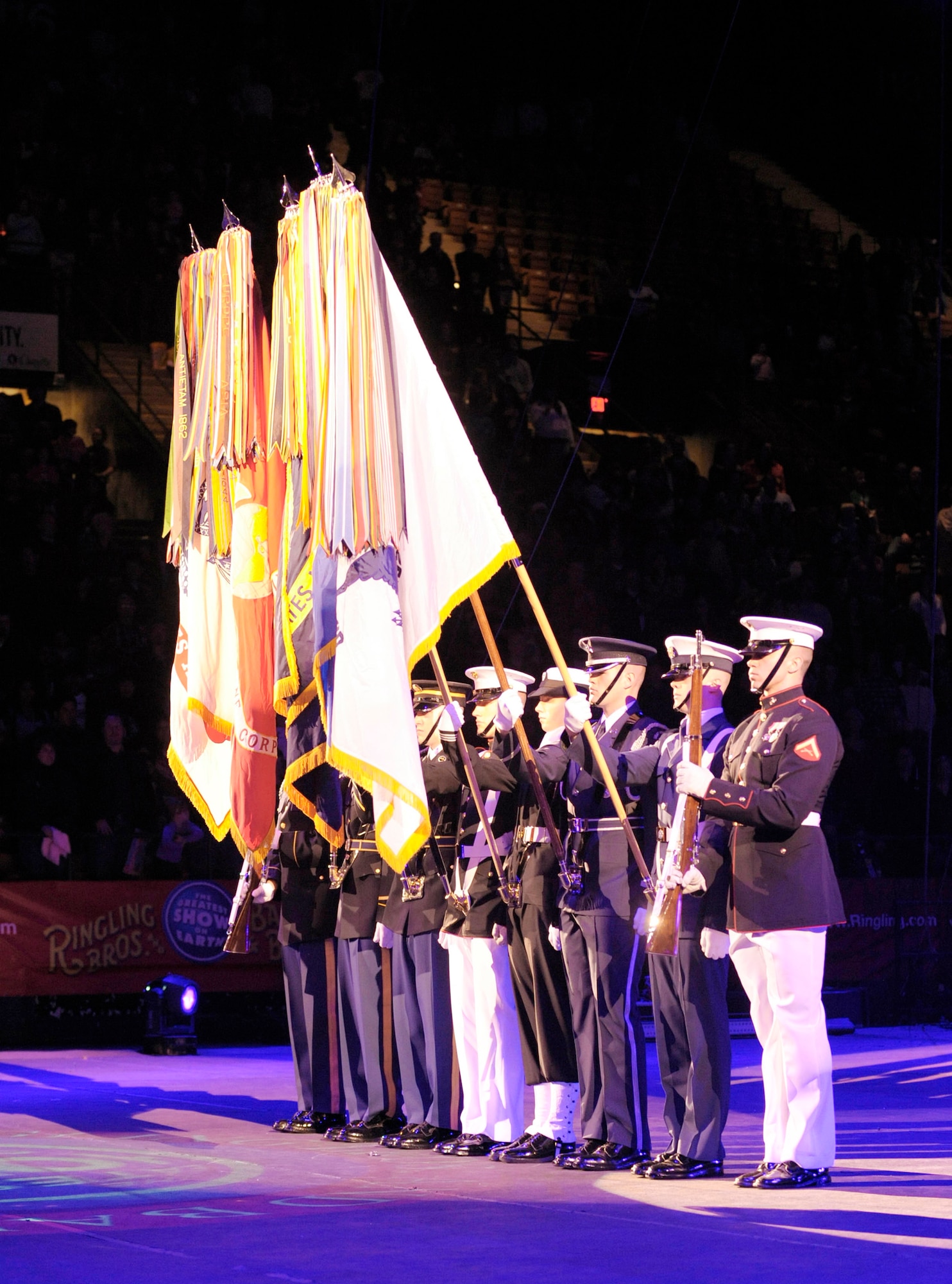 The Military District of Washington's Joint Color Guard present the flags at the beginning of the Ringling Bros. and Barnum & Bailey "Zing Zang Zoom" circus performance March 26, 2010, at George Mason University's Patriot Center in Fairfax, Va. This particular performance was in honor of military families worldwide.  (U.S. Air Force photo/Jim Varhegyi)