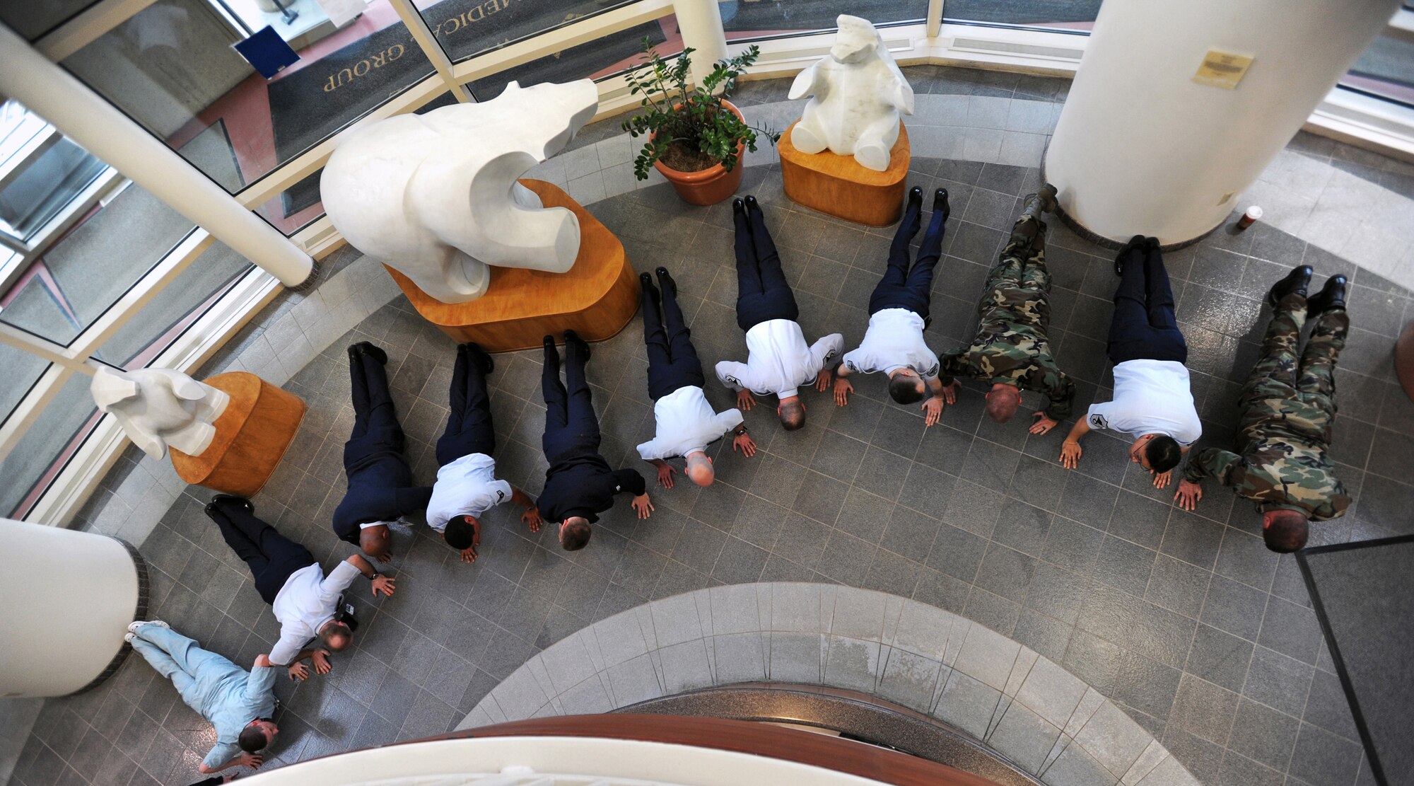 ELMENDORF AIR FORCE BASE, Alaska -- Arctic Medics do push-ups in the lobby of the Elmendorf AFB hospital for the 100-day million push-up challenge March 29. In an attempt to improve PT scores and unit camaraderie, 425 Arctic Medics did 1,184,957 push-ups in 100 days. (Air Force photo by Senior Airman Laura Turner)