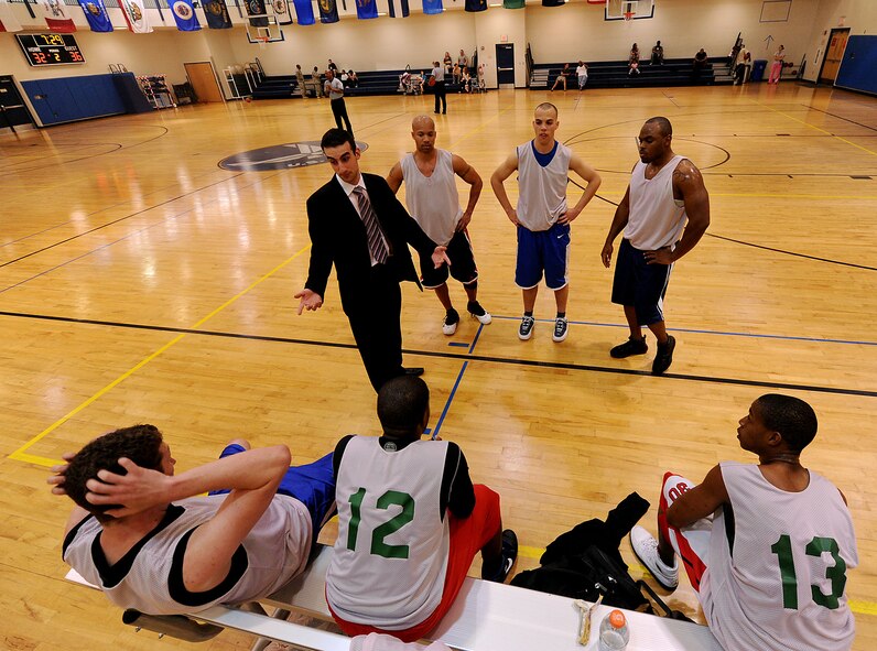 MOODY AIR FORCE BASE, Ga. -- The 23rd Maintenance Operations Squadron intramural basketball team talk strategy during a timeout late in the second quarter of the championship game here March 26. The 23rd Medical Group couldn’t hold on to the lead squandering their chance to become the base champs. (U.S. Air Force photo by Airman 1st Class Joshua Green/RELEASED)