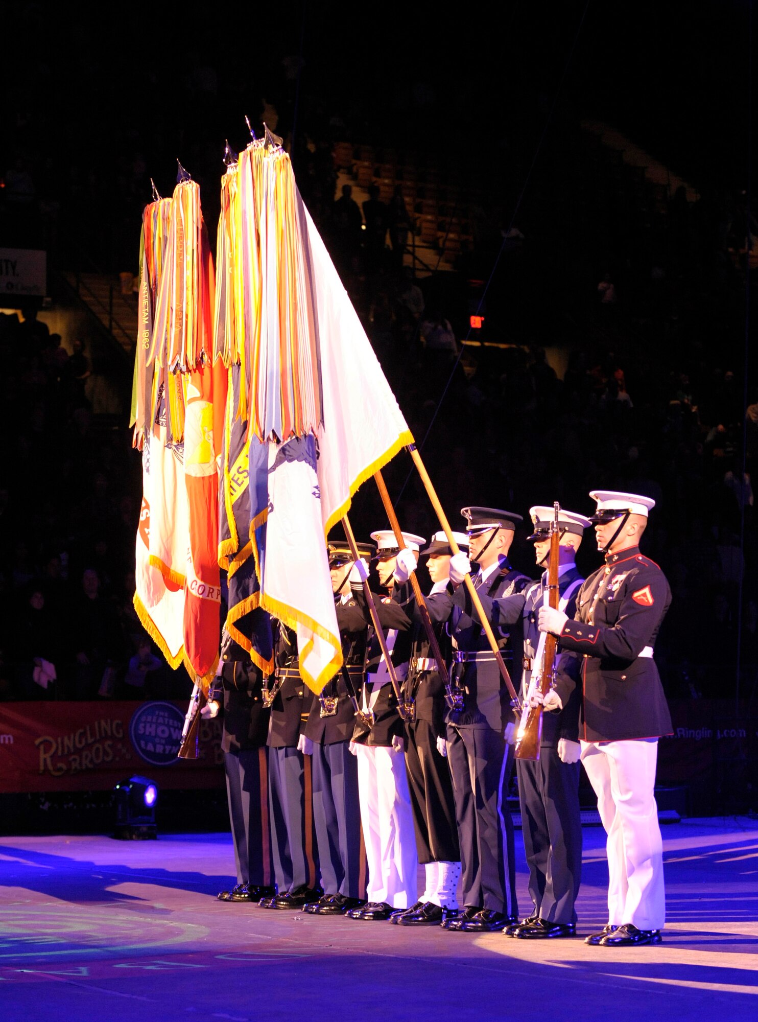 The Military District of Washington's Joint Color Guard present the flags at the beginning of the Ringling Bros. and Barnum & Bailey "Zing Zang Zoom" circus performance at George Mason University's Patriot Center March 26, 2010, Fairfax, Va. Air Force Master Sgt. Cameron Rogers and his family served as guest ringmasters for the performance. Sergeant Rogers recently returned from a year-long deployment to Afghanistan and currently is the Air Force District of Washington's UH-1N helicopter program manager at Bolling Air Force Base, Washington. The Rogers family was asked to serve as guest circus ringmasters representing military families worldwide in observance of Year of the Air Force Family. (U.S. Air Force photo/Jim Varhegyi)