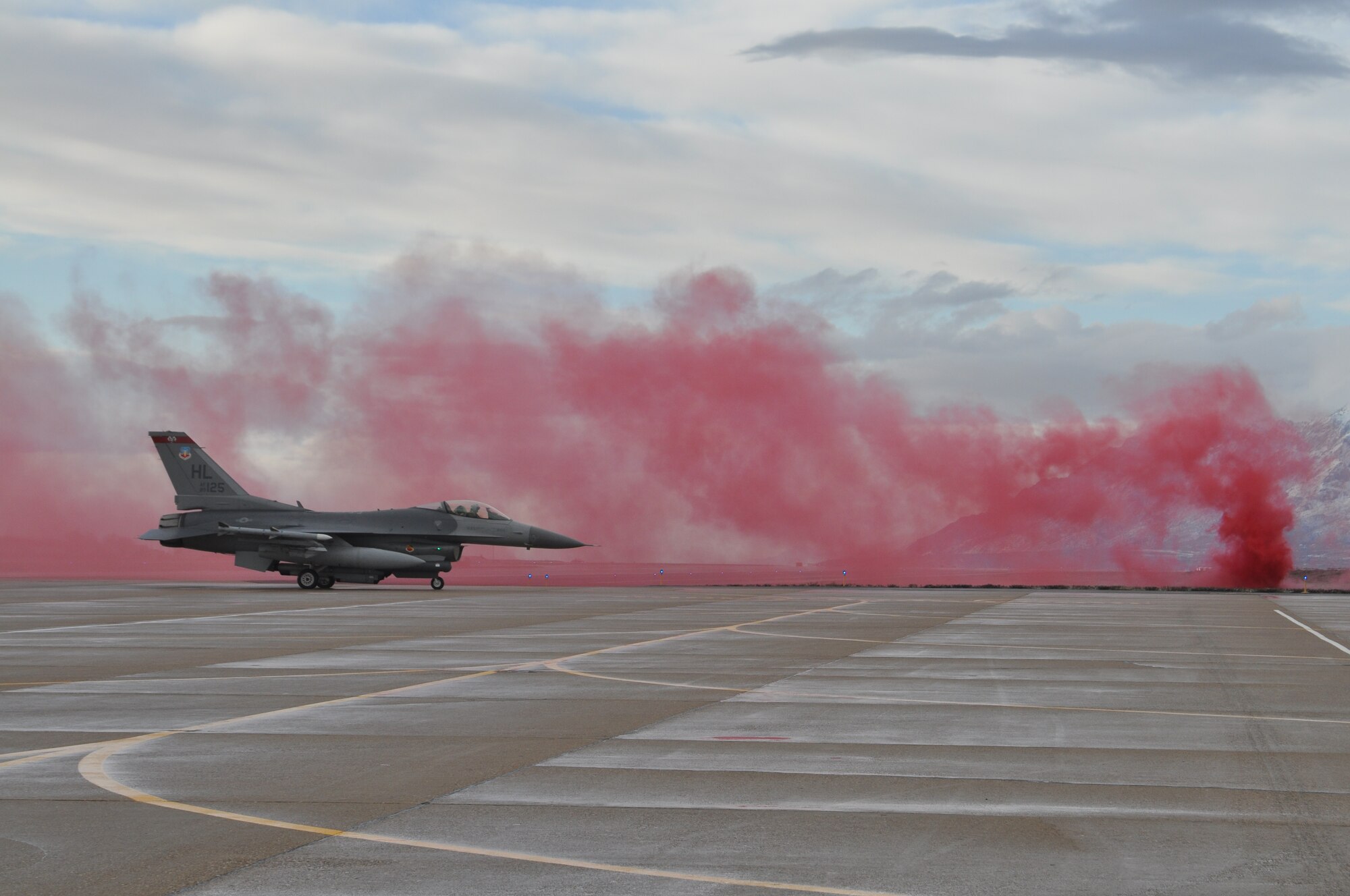 An F-16 from the 388th Fighter Wing taxis by red smoke in a simulated attack during last week’s Operational Readiness Exercise at Hill Air Force Base. (U.S. Air Force photo/Staff Sgt. Kyle Brasier)