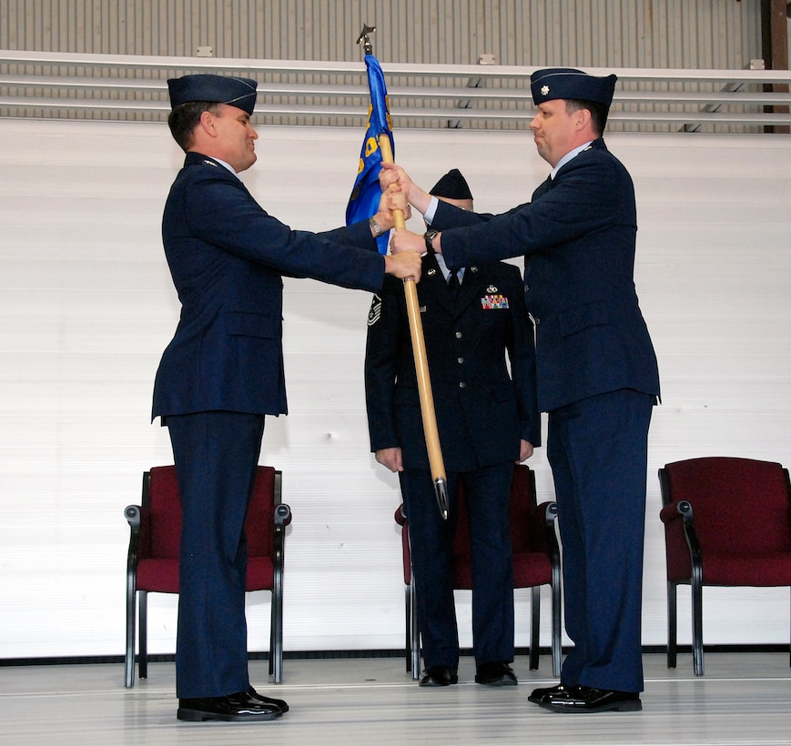 Lt. Col. Barry Cook (right), incoming 80th Operations Support Squadron commander, accepts the command of the squadron from Col. Glen Lawson(left), 80th Operations Group deputy commander, March 26 during the squadron's change-of-command ceremony at Bldg. 2550 Sheppard Air Force Base, Texas.  Lt. Col. Michael Messer, the outgoing 80th OSS commander, relinquished command. (U.S. Air Force photo/Mike Litteken)